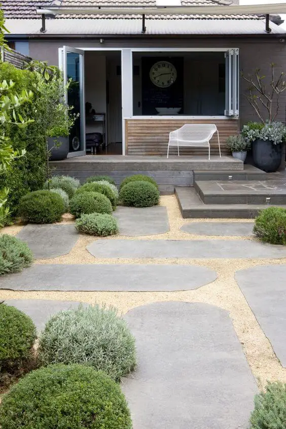 Photo of modern garden paving in the backyard of a house. Modern Garden Paving ideas.